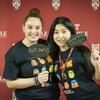 Two female students holding up "Temple