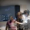 Three students using a virtual reality headset